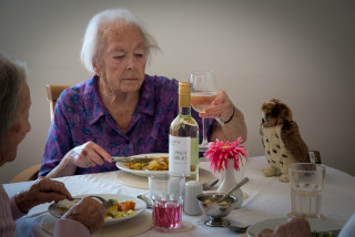 Hollybank residents at dinner with wine